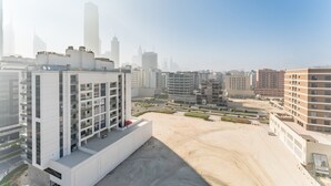 A high-rise building with multiple floors and balconies, surrounded by other high-rise buildings and a large open area with minimal landscaping. - Mins from City Walk, Downtown Dubai and Jumeirah Beach, Easy Access to Metro Stations (Dubai)