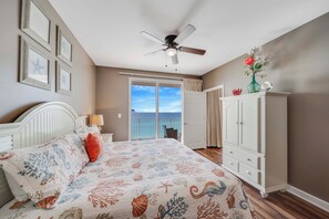 A bedroom with a bed, ceiling fan, and a view to the outside. - NEW Listing! FREE Daily Golf&Perks! Splash W502 w/Hot Tub & Heated Pool &Gym! (Panama City Beach)