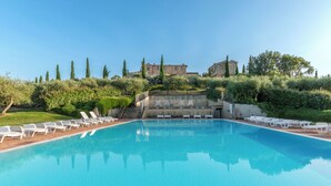 A swimming pool with lounge chairs and a staircase leading to a building. - Apartment la Torre, Palazzo Monaci - with Swimming Pool in the Crete Senesi (Toscana)