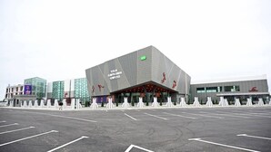 A modern building with a unique angular design, featuring a prominent entrance and a large glass facade. - Arena Hotel Yevlakh (Yevlakh)