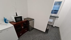 A compact kitchenette with a microwave, toaster, and refrigerator. - Fantastic Inn Warsaw - Jasna (Warsaw)