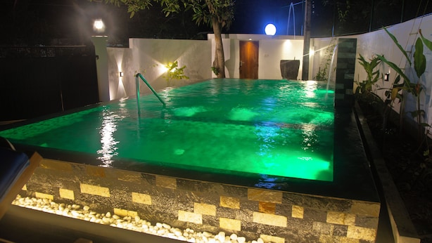 A rectangular swimming pool with a tiled edge and a pebble-lined bottom. - Sea Bloom Villa (Thalaramba)