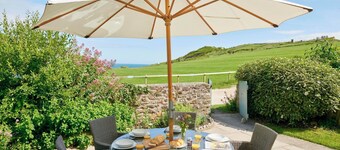 A charming traditional coastguard cottage boasting a private garden, a cozy wood burner, and breathtaking views of Lulworth Cove. This delightful retreat is an ideal holiday destination for discovering the wonders of Dorset. Sleeps six people across
