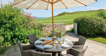 A charming traditional coastguard cottage boasting a private garden, a cozy wood burner, and breathtaking views of Lulworth Cove. This delightful retreat is an ideal holiday destination for discovering the wonders of Dorset. Sleeps six people across