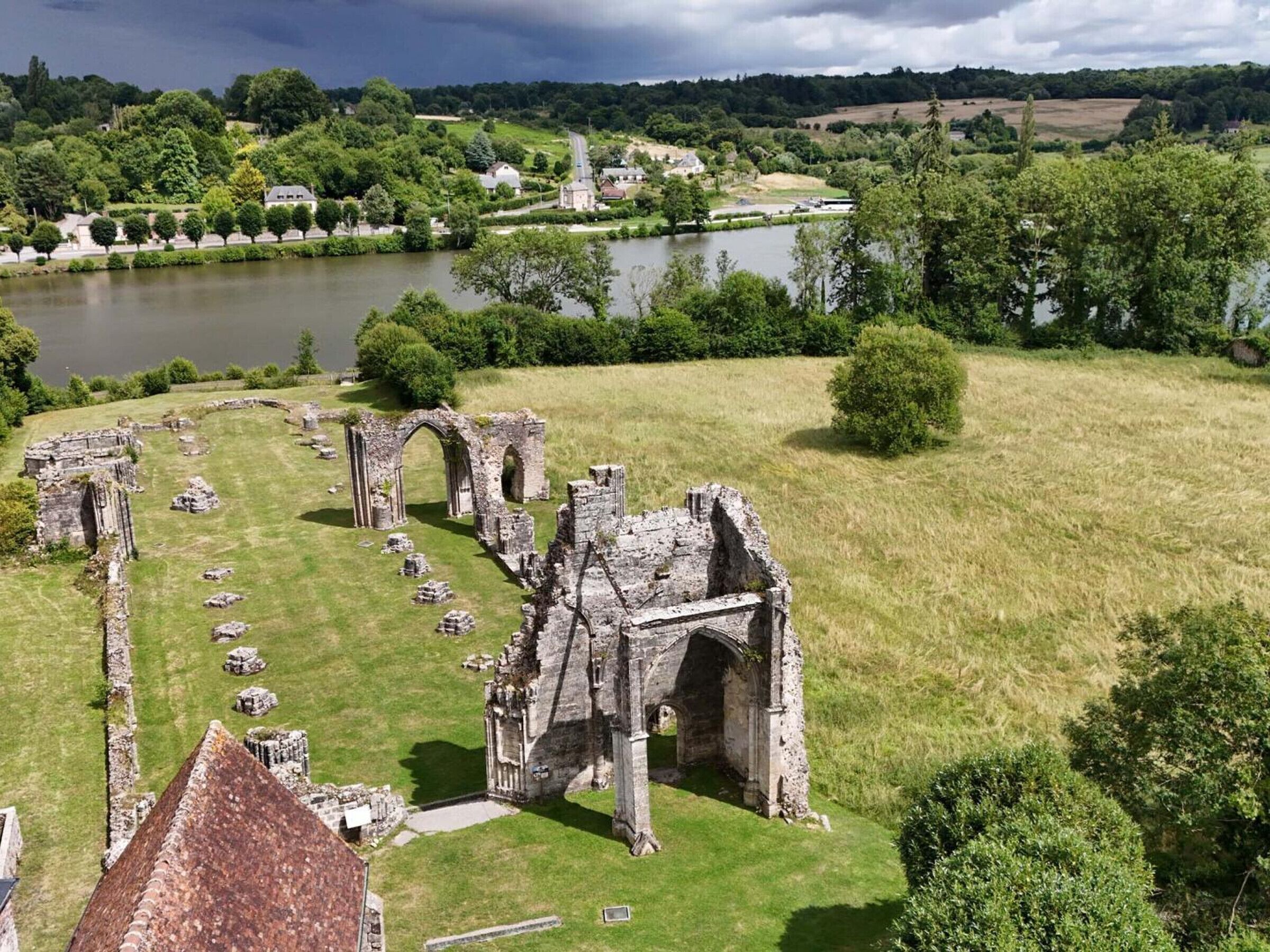 An aerial view of a historic site with ruins and a river.