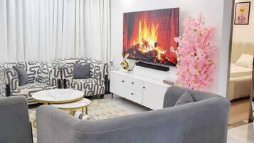 Deluxe Apartment, City View | Living area | 32-inch Smart TV with digital channels
