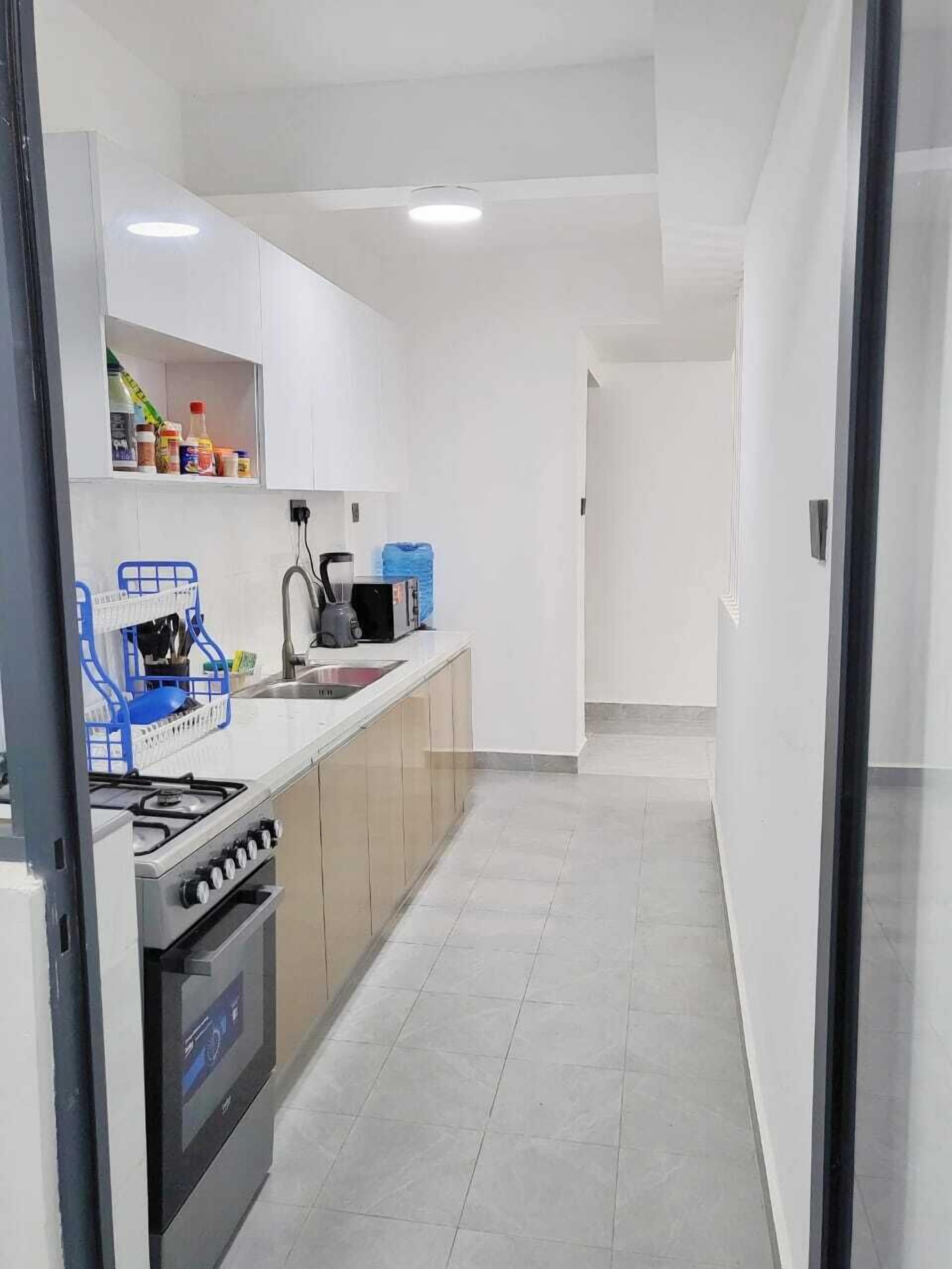 Een koelkast, een magnetron, kookgerei, borden en bestek