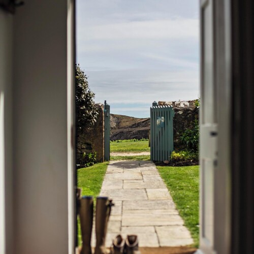 A beautifully appointed traditional coastguard cottage featuring a private garden and stunning views of Lulworth Cove in Dorset. Sleeps up to five people in three bedrooms.