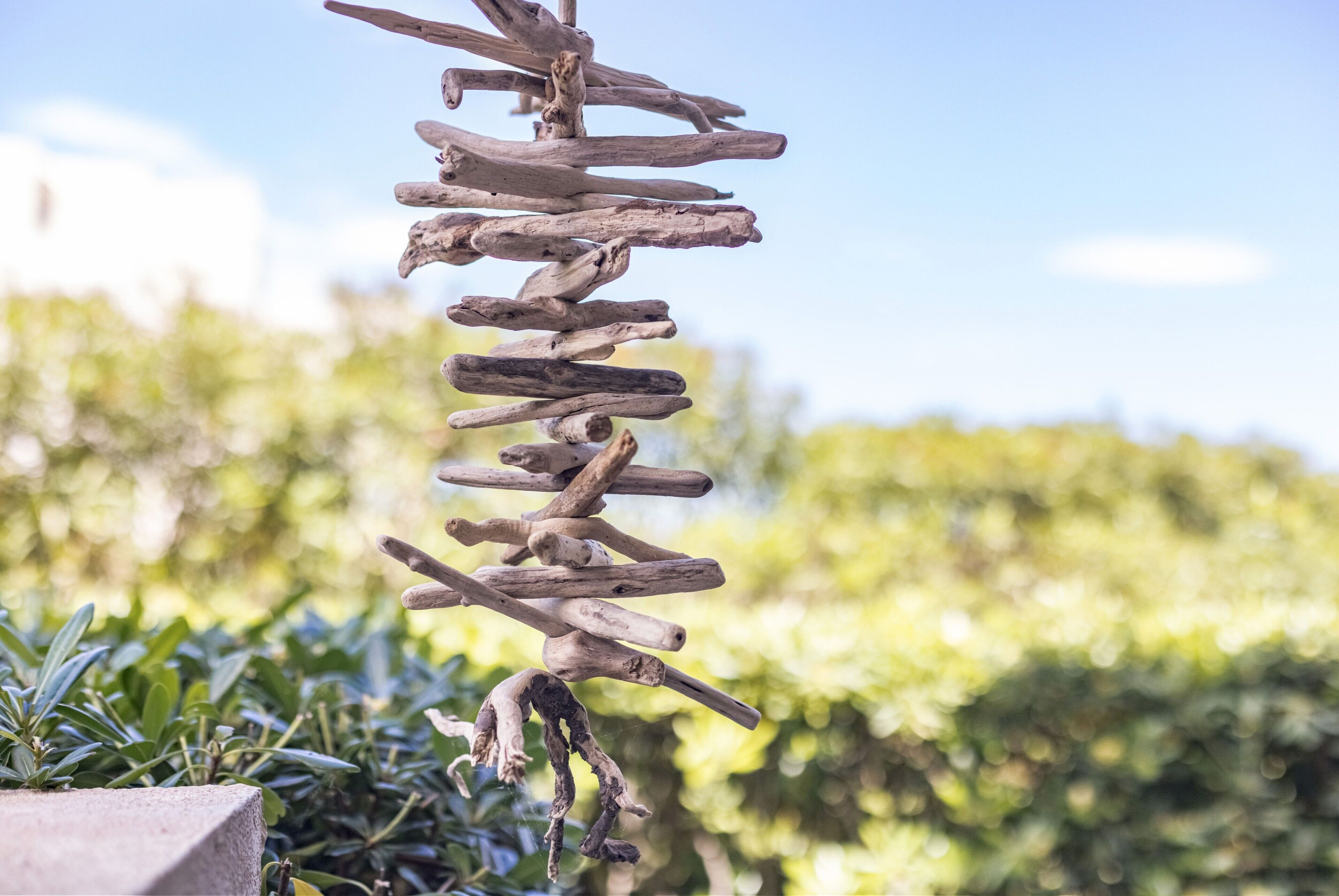 A vertical arrangement of wooden branches.