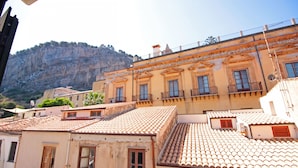 A building with a tiled roof and multiple balconies. - Terrazza Cathedral by Wonderful Italy (Cefalù)