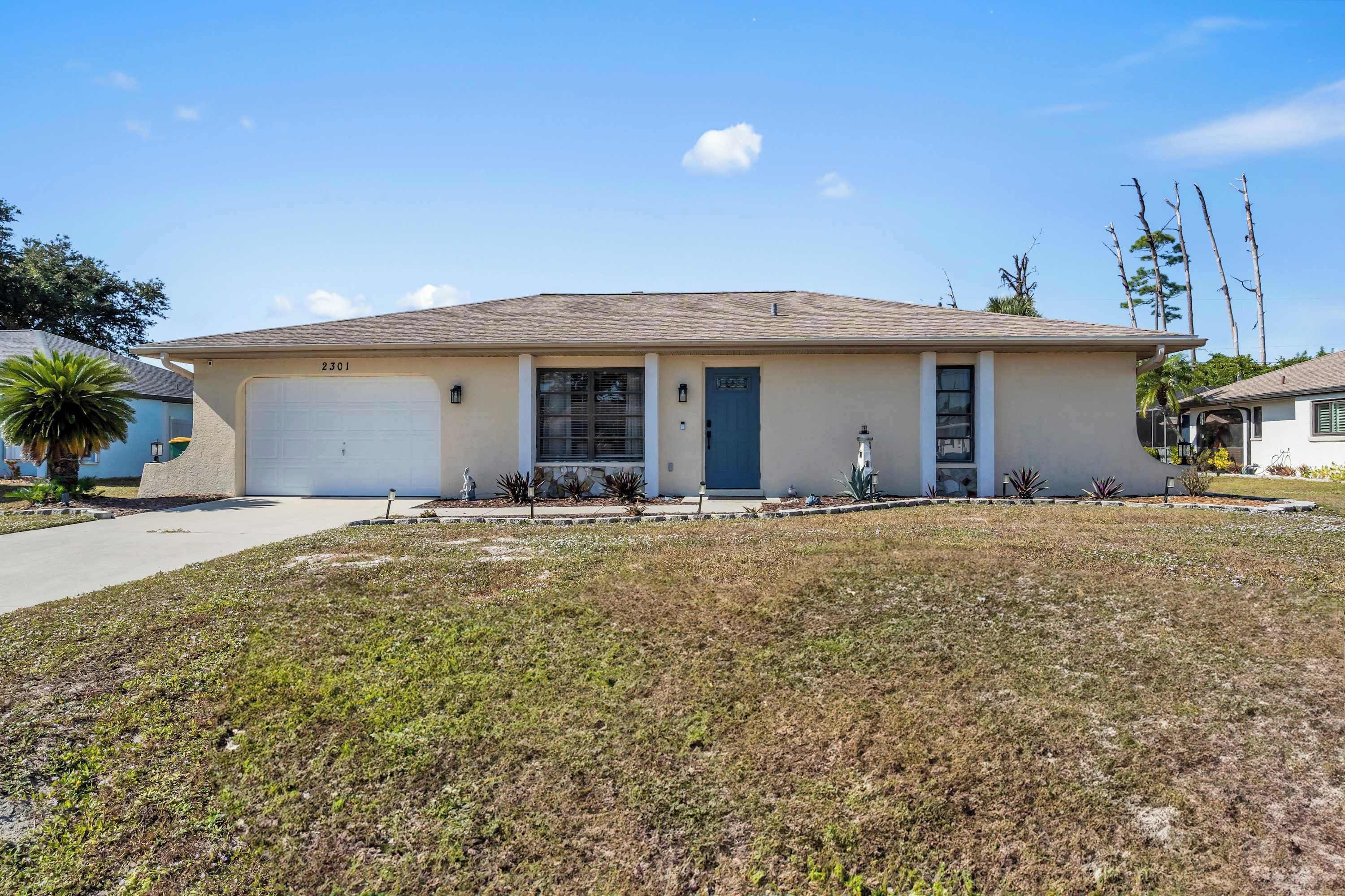 A single-story house with a garage, a front porch, and a well-maintained lawn.