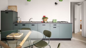 A modern kitchen with a central island, a dining table with chairs, and pendant lights. - Elchann - El Chi Ma by Wonderful Italy (Polizzi Generosa)