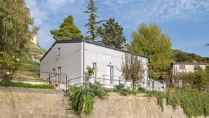 A building with the name 'ELCHIMA' on its facade, surrounded by greenery and a stone wall. - Elchann - El Chi Ma by Wonderful Italy (Polizzi Generosa)