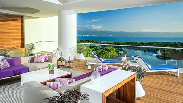 A modern lounge area with a pool, outdoor seating, and a view of the sea. - GRAND LUXXE - THE RESIDENCE FOUR BEDROOM TOWER (Las Jarretaderas)