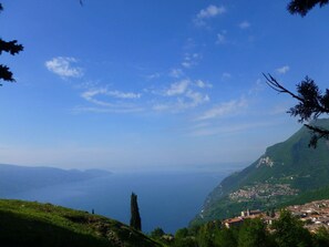 A mountainous landscape with a village nestled in the valley. - Appartamento Panoramico by Theater Home - with big terrace and marvellous lake view (Tignale)