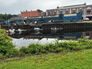 A boat yard with several boats docked, a building labeled "Boat Yard," and a reflection in the water. - Entire Private 1 bedroom apartment ✨XL bathroom💄👔✨Breakfast included🥞 (Norwich)