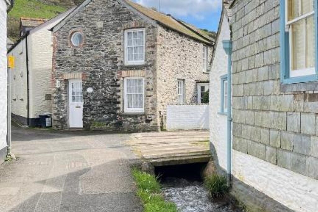 A stone building with a small entrance and a wooden door.