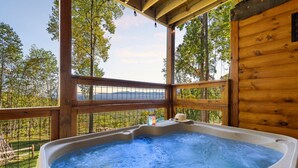 A hot tub in a wooden cabin with a view of trees and mountains. - Twin Summit Resort (Sevierville)