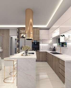 A modern kitchen with a central island, stainless steel appliances, and a wooden accent wall. - Sunset Dream Luxury Villa (Zakynthos)