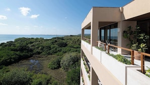 A modern building with a balcony overlooking a coastal landscape. - Patamar Luxury Condo - Includes Chef, Maid & Premier Access (Punta Mita)