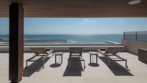 A rooftop terrace with three lounge chairs and a pool view. - Patamar Luxury Condo - Includes Chef, Maid & Premier Access (Punta Mita)