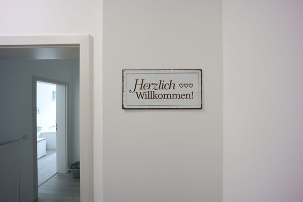 A hallway with a welcome sign on the wall.