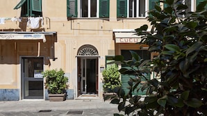 A building with a ground-floor shop named "Cucchi" and a door marked with the number 68. - A Un Passo Dalla Spiaggia di Camogli by Wonderful Italy (Camogli)
