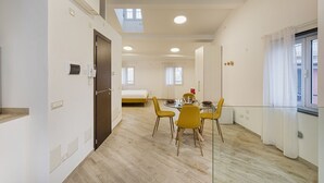 A modern apartment with a dining area, a bedroom, and a living space. - Il Veliero Loft by Wonderful Italy (Genoa)