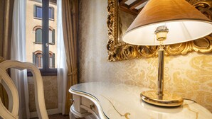 A room with a white curved vanity, a gold-framed mirror, and a table lamp. - Ca di Malta Room 1 by Wonderful Italy (Venice)