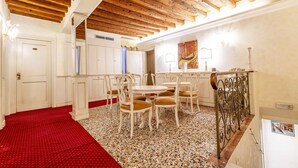 A dining area with white furniture, a red carpet, and a wooden ceiling. - Ca di Malta Room 1 by Wonderful Italy (Venice)