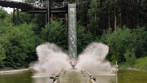 A water slide with a central drop and two exits, surrounded by dense greenery. - Knuthenborg Safaripark (Bandholm)