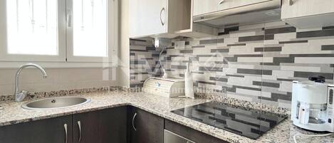 Fridge, microwave, coffee/tea maker, cookware/dishes/utensils