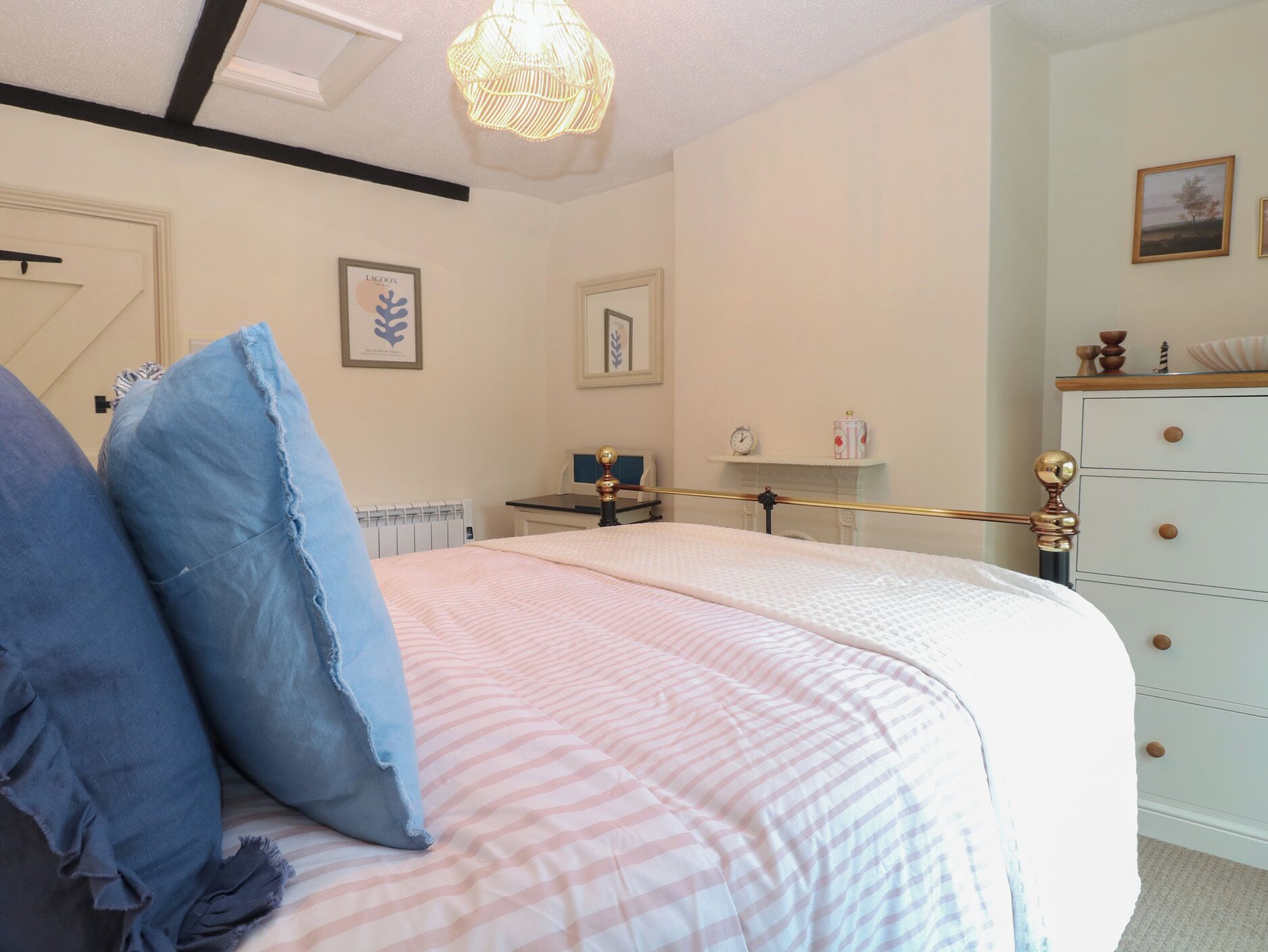 Ein Schlafzimmer mit Bett, Schminktisch, Nachttisch und Lampe.