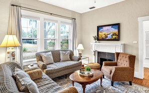 A living room with a fireplace, a sofa, a chair, and a coffee table.