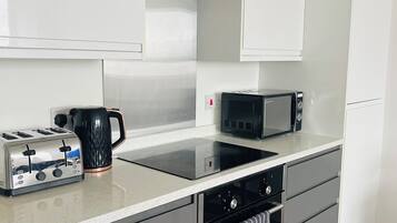 Coffee/tea maker, fridge, microwave, oven