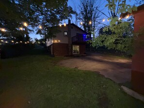 A house with a brick exterior, a visible garage door, and a pathway leading to the entrance. - The Resorts World Retreat Spacious 4-bedroom house in beautiful Monticello (Monticello)