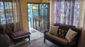 A living room with a sofa, a bench, and a patterned rug.