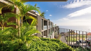 A modern building with a balcony overlooking a coastal view. - Orion Calheta Hills by LovelyStay (Calheta)