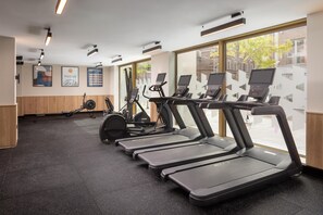 A gym with treadmills, a stationary bike, and a rowing machine. - Home2 Suites By Hilton Dublin City Centre (Dublin)