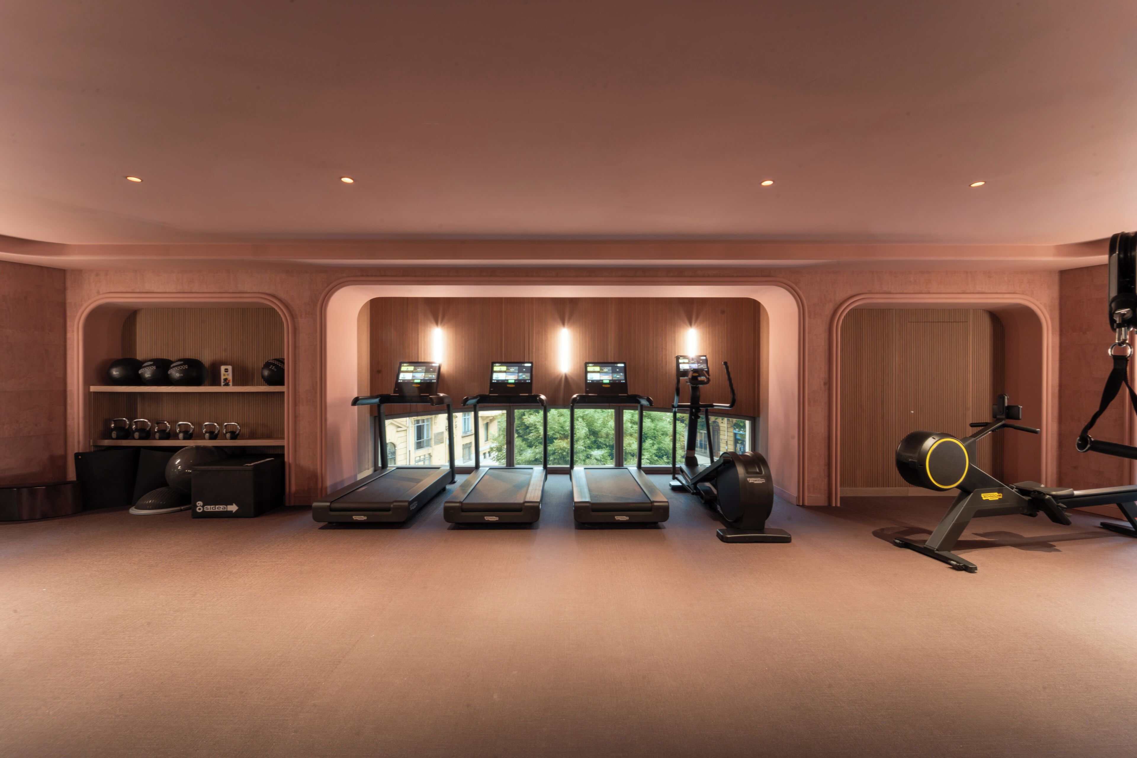 A gym with treadmills, exercise bikes, and a rowing machine.
