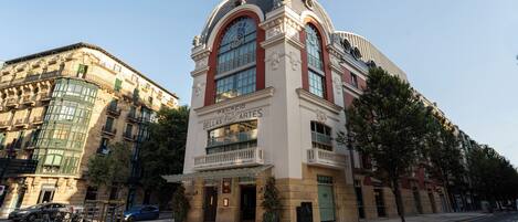 A historic building with a prominent clock tower and a sign reading 'Bellas Artes.'