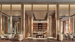 A spacious lobby with wooden paneling, a central seating area, and a visible staircase. - Hilton Burau Bay Langkawi Resort (Langkawi)