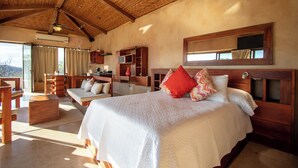 A spacious bedroom with a large bed, wooden headboard, and a ceiling fan. - Spacious luxury villa minutes from town, nearby beaches and attractions! (San Juan del Sur)