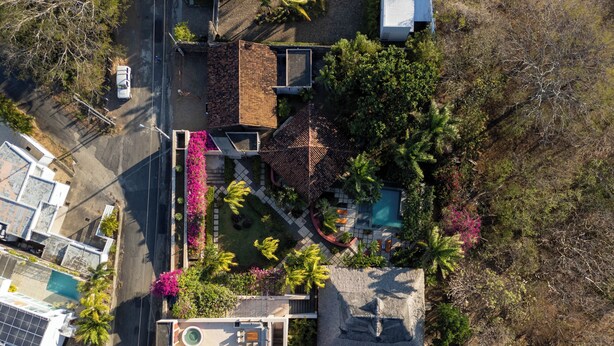 An aerial view of a residential property with a swimming pool, a patio area, and a small garden with various plants. - Spacious luxury villa minutes from town, nearby beaches and attractions! (San Juan del Sur)