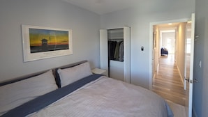 A bedroom with a bed, a closet, a hallway, and a ceiling fan. - Talk about Location!!!!    Across from the Beach,Lucy & the GreenHouse (Margate City)