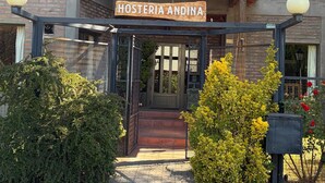 A building with a sign reading "HOSTERIA ANDINA" at the entrance. - Hosteria Andina (Esquel)