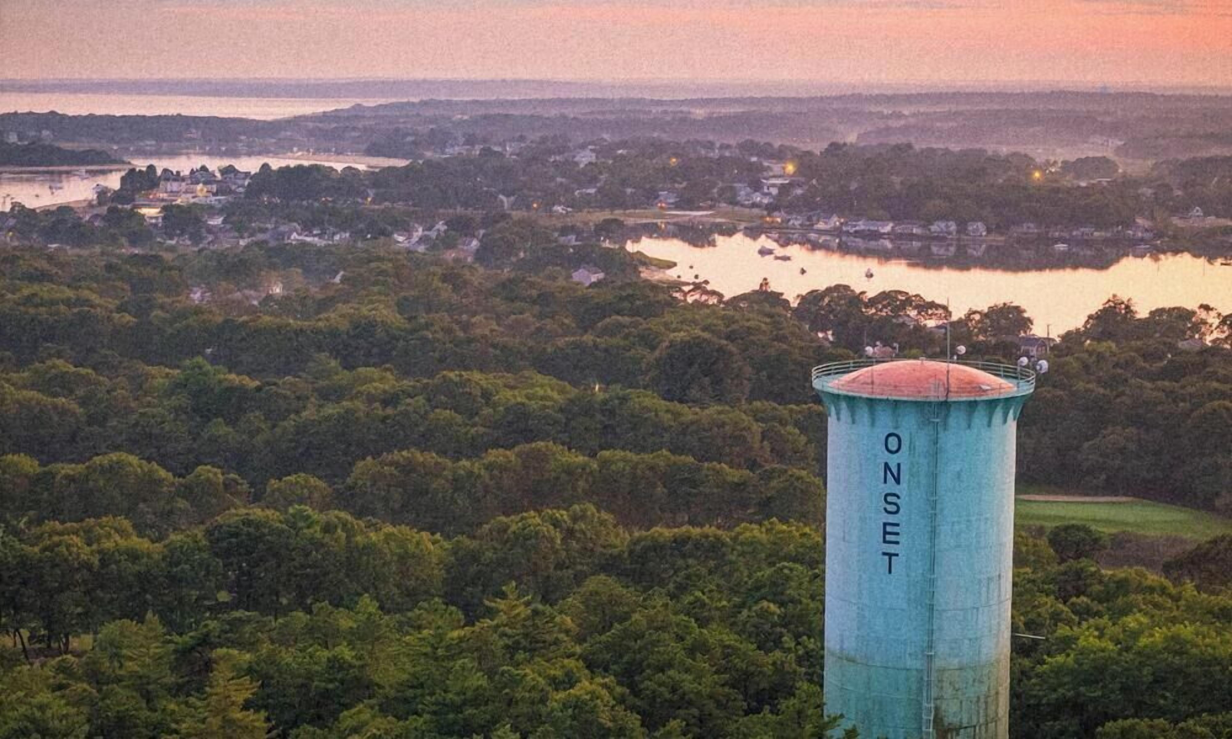 A water tower labeled 'ONSET' with a view of a lake and surrounding forest.