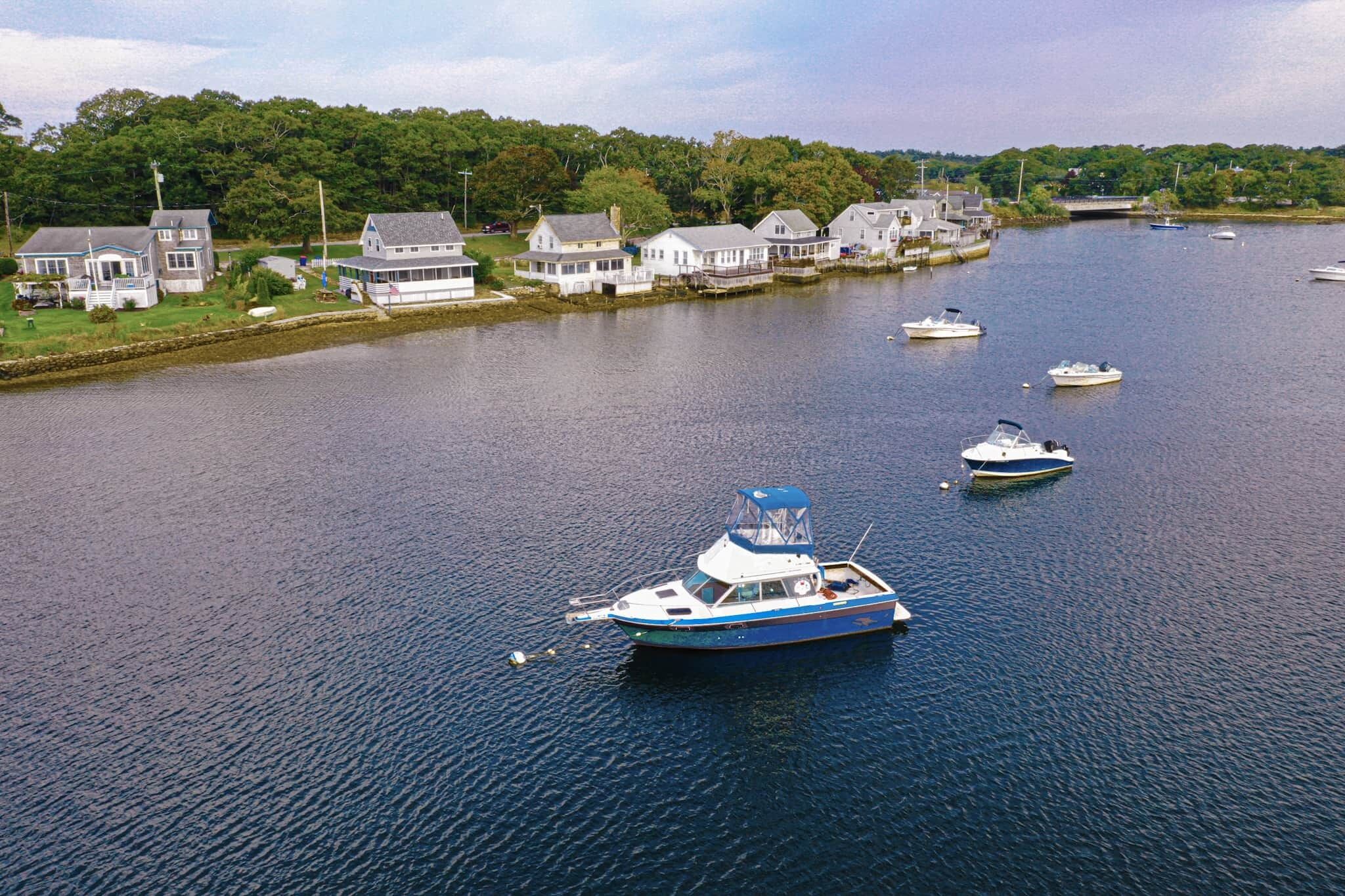 A river with boats and houses along the shore.