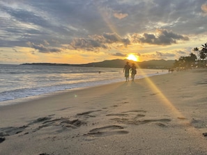 A beach scene with footprints leading to the water, palm trees, and a sunset in the background. - Rustic private 2BR/1.5ba house with yard in Bucerías Centro near Puerto Vallarta (Bucerías)