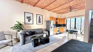 A modern living room with a grey sofa, two black coffee tables, and a large window. - Lirio, Ajijic (Ajijic)